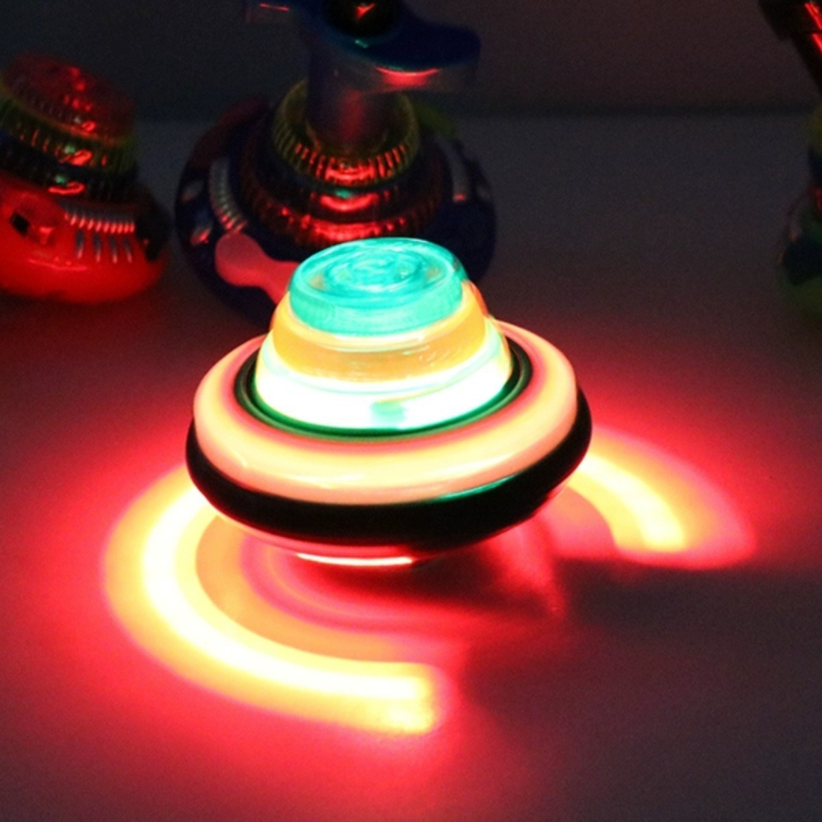 12 Spinning Top with Lights & Music Light Up Peg Tops LED Spin Toys (Multicolor)